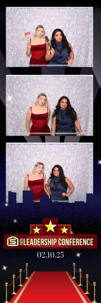 Two women pose together in a series of three photos at the 2025 Leadership Conference, captured by a digital photo booth. One wears a red dress and holds a wooden gavel, while the other is in blue. They stand against a silver backdrop with conference graphics below.