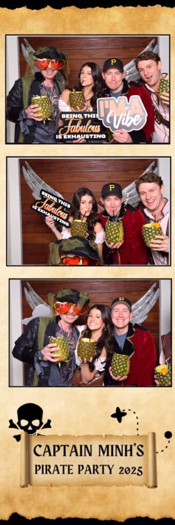 Four people at a pirate-themed party pose in a Digital Photo Booth with props like pineapples, oversized glasses, a pirate hat, and playful signs. All smile brightly beneath a banner that reads: Captain Minh&rsquo;s Pirate Party 2025.